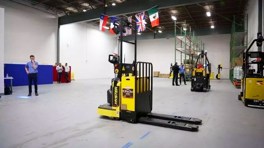 Robotic Hyster End Rider and other autonomous vehicles in warehouse. 