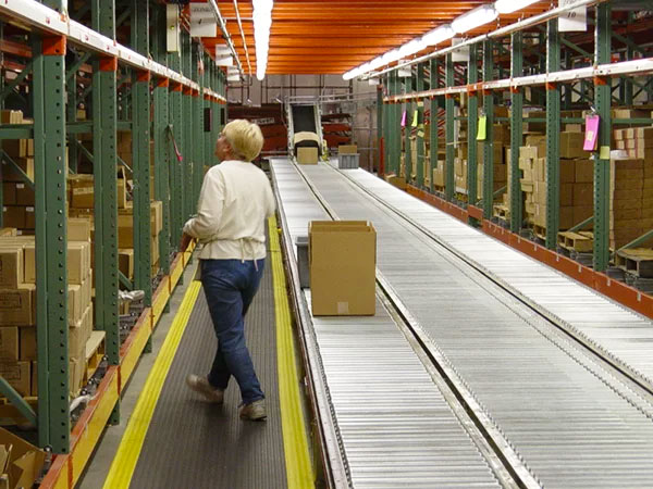 Warehouse conveyor transporting boxes of picked materials.