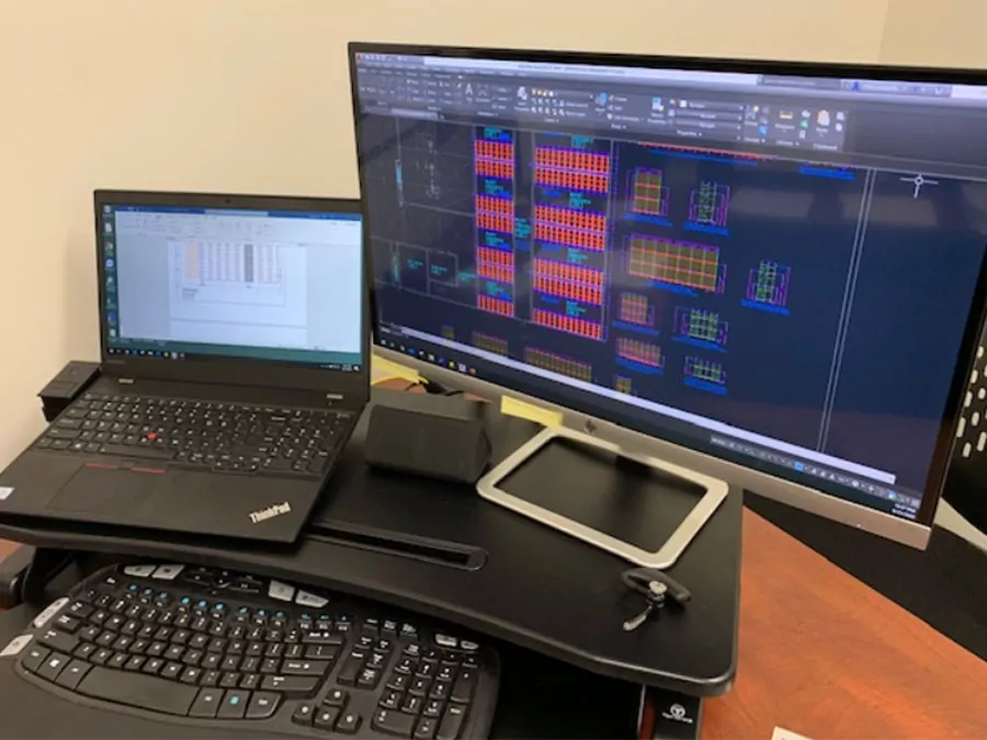 Laptop and computer monitor showing warehouse design and planning program.