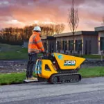 JCB HTD-5E electric dumper driving on road outdoors.