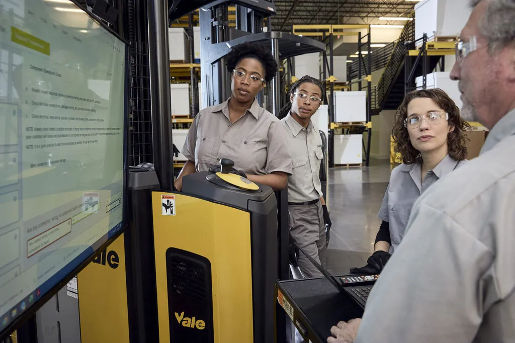 Individuals learning equipment safety training. 