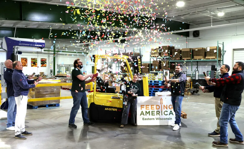 Feeding America cutting the ribbon on their donated Hyster lift truck.