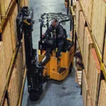 Bendi B3/30AC forklift raising pallet off warehouse racking.