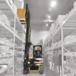 Drexel R60i5 forklift placing pallet on warehouse racking.