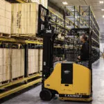 Landoll LSC30AC forklift lifting pallet off warehouse racking.