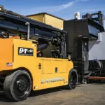 Landoll PT40 telehandler lifting large machine.