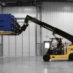 Landoll PT40 telehandler raising large pallet of materials in a warehouse.