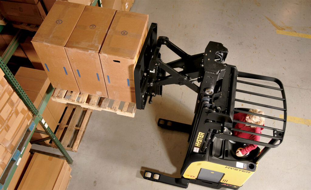 Hyster reach truck lifting pallet onto racking.