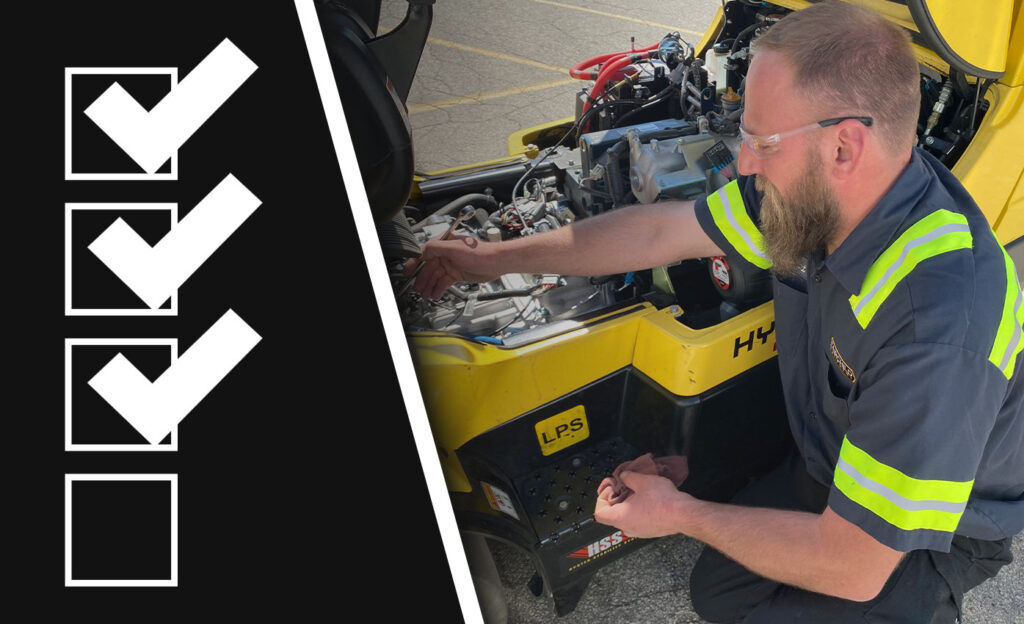 Technician repairing lift truck.