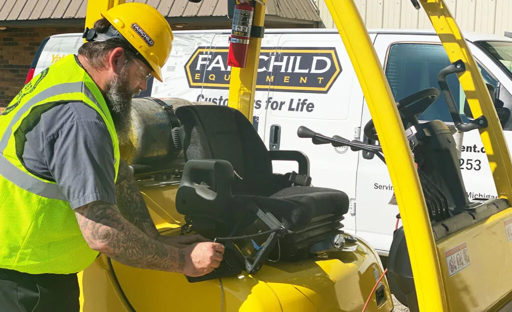 Certified forklift technician scanning Hyster forklift.
