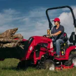 Mahindra Sub-Compact 1100 Series Tractor in field with bucket loader.