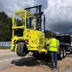 Donkey The Jack forklift being mounted on the back of a truck.