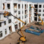 JCB AJ48D boom lift raised at jobsite.