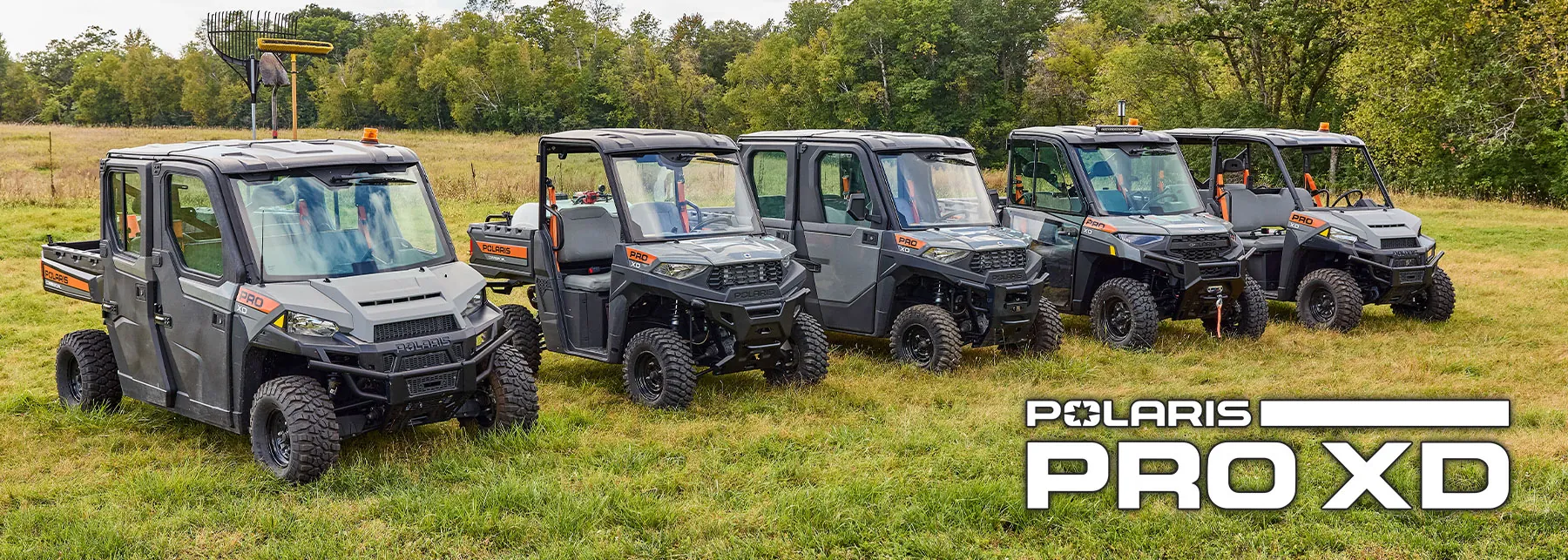 Pro XD Utility Vehicles lined up in grass field.