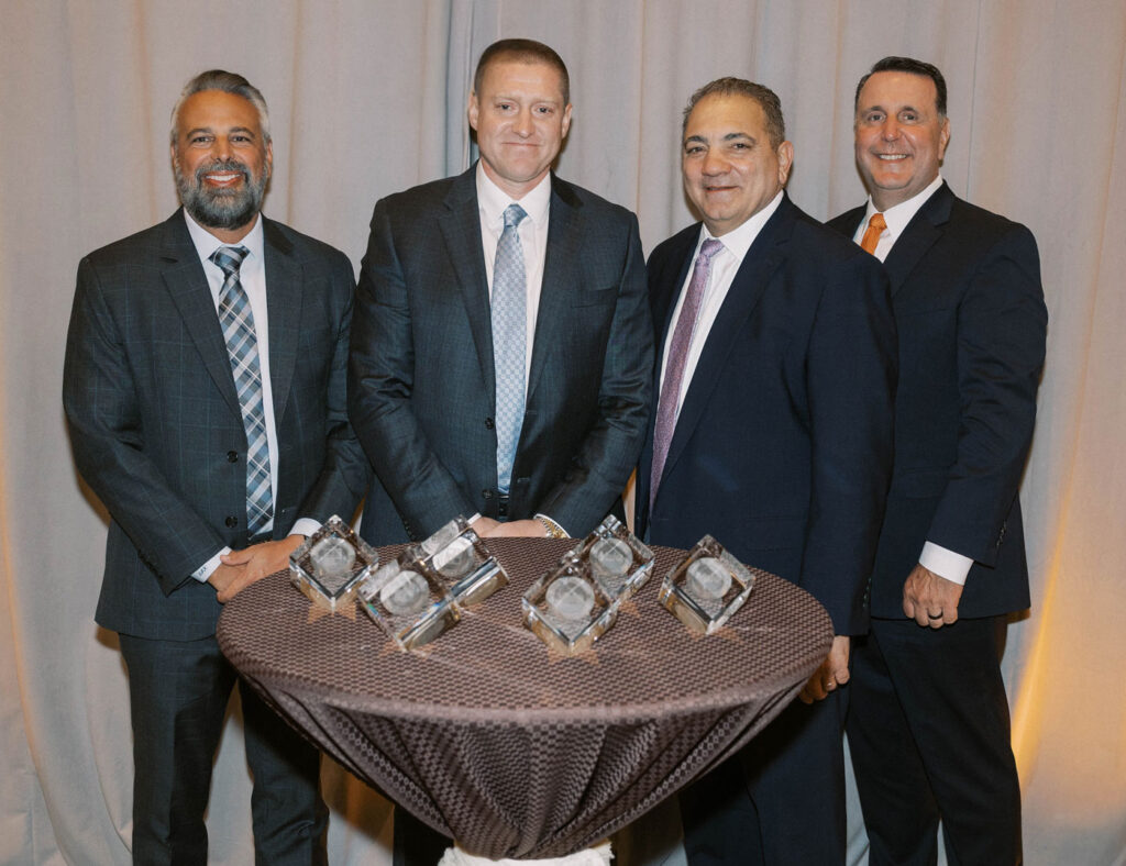 Fairchild CEO accepting Hyster dealer of distinction award with HYMH executive team.