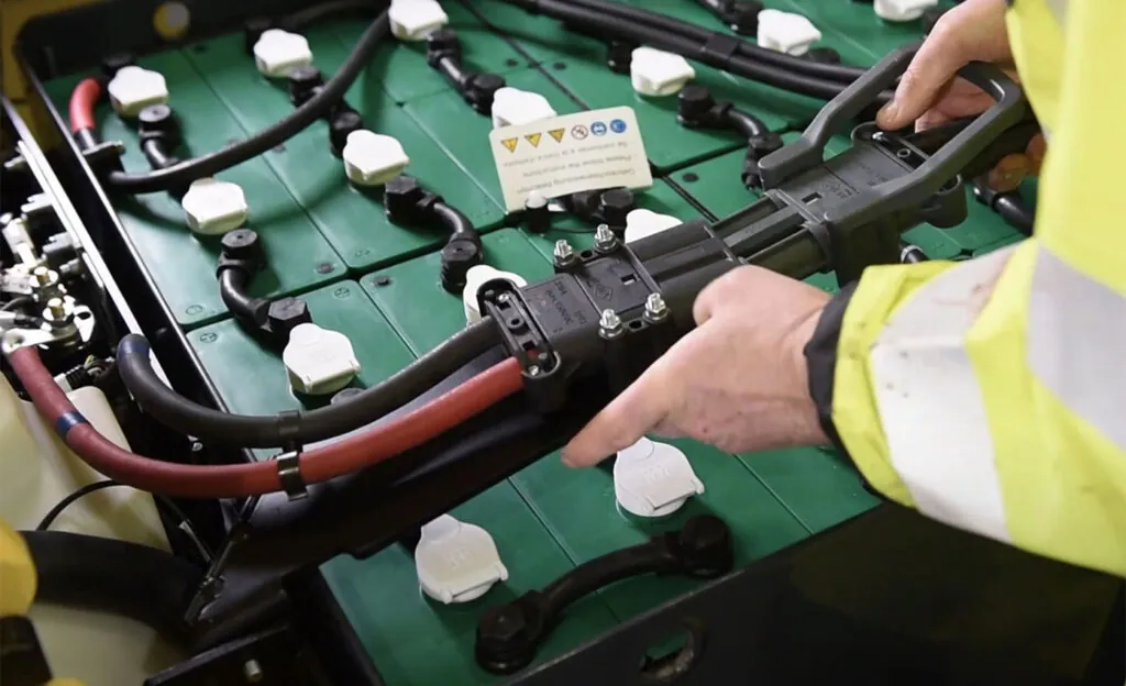 Forklift battery getting plugged in.