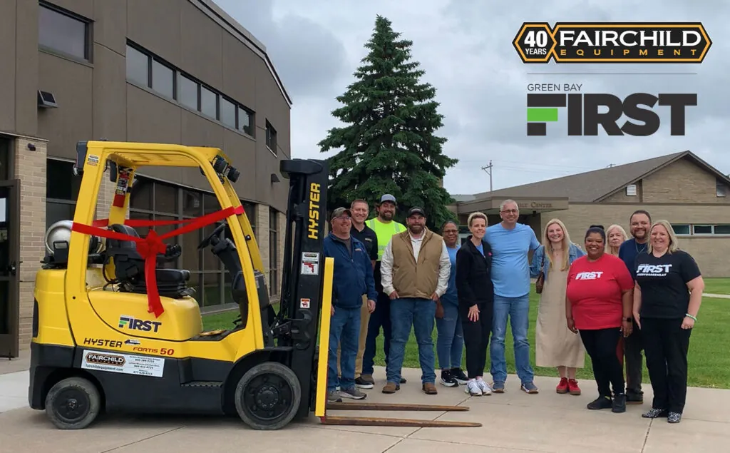 Fairchild Equipment and Green Bay First employees next to the donated Hyster forklift.