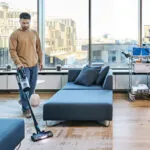 Worker vacuuming lobby with the Advance VU200 upright vacuum.