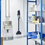 Advance VU200 upright vacuum being stored on wall in work closet.