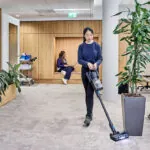 Advance VU200 upright vacuum cleaning floors in office.