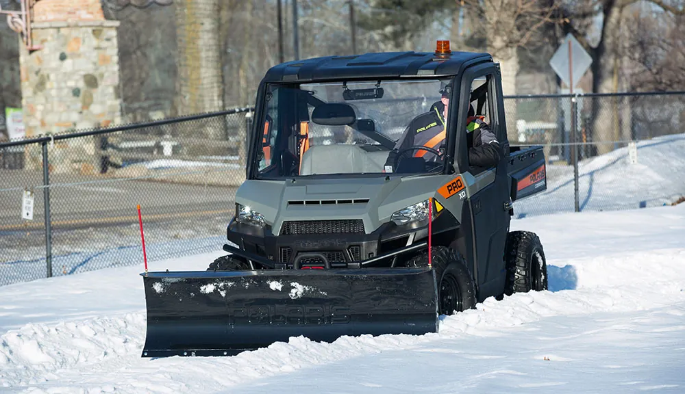 Polaris Commercial Pro XD utility vehicle plowing snow.