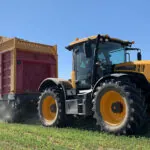 JCB 4220 Fastrac agricultural tractor doing farm fieldwork. .