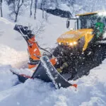 JCB 4220 Fastrac with plow attachment clearing snow.