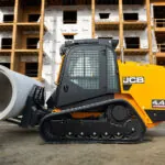JCB 4TS-8T Teleskid transporting large concrete materials at job site.