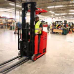 Mariotti MIP 10 electric counterbalanced forklift driving through warehouse shop.