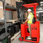 Mariotti MIP 10 electric forklift lifting pallet onto pallet racking.