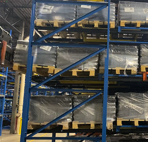 forklift placing pallet on pushback pallet racking.